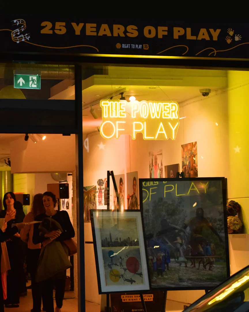 An exterior shot of the exhibition, with a neon sign saying "The Power of Play"
