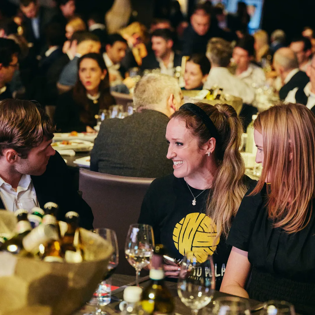 Right To Play Ambassador Grace Prendergast sits at a table chatting to guests and staff