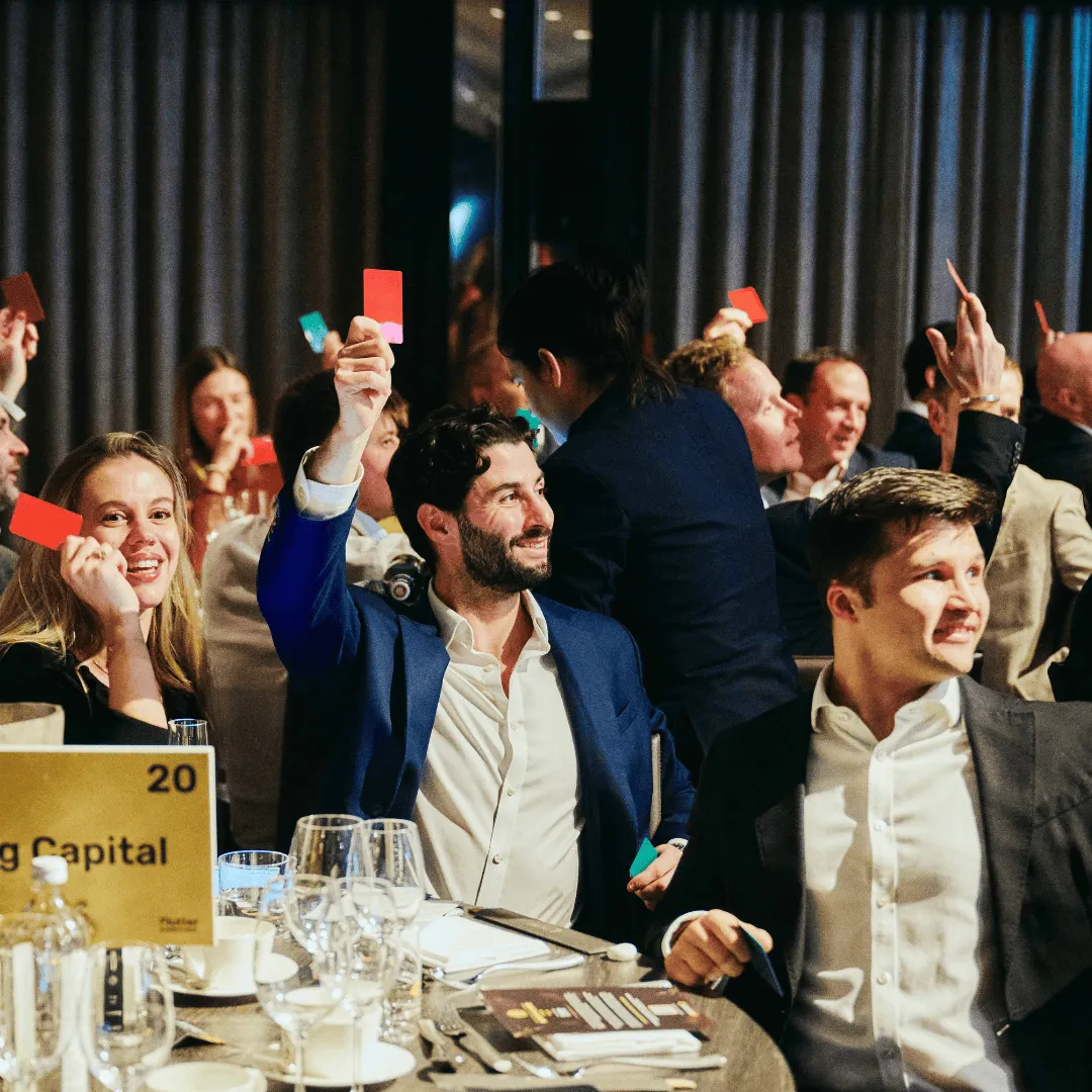 Guests hold up red and green cards in the first game of the night