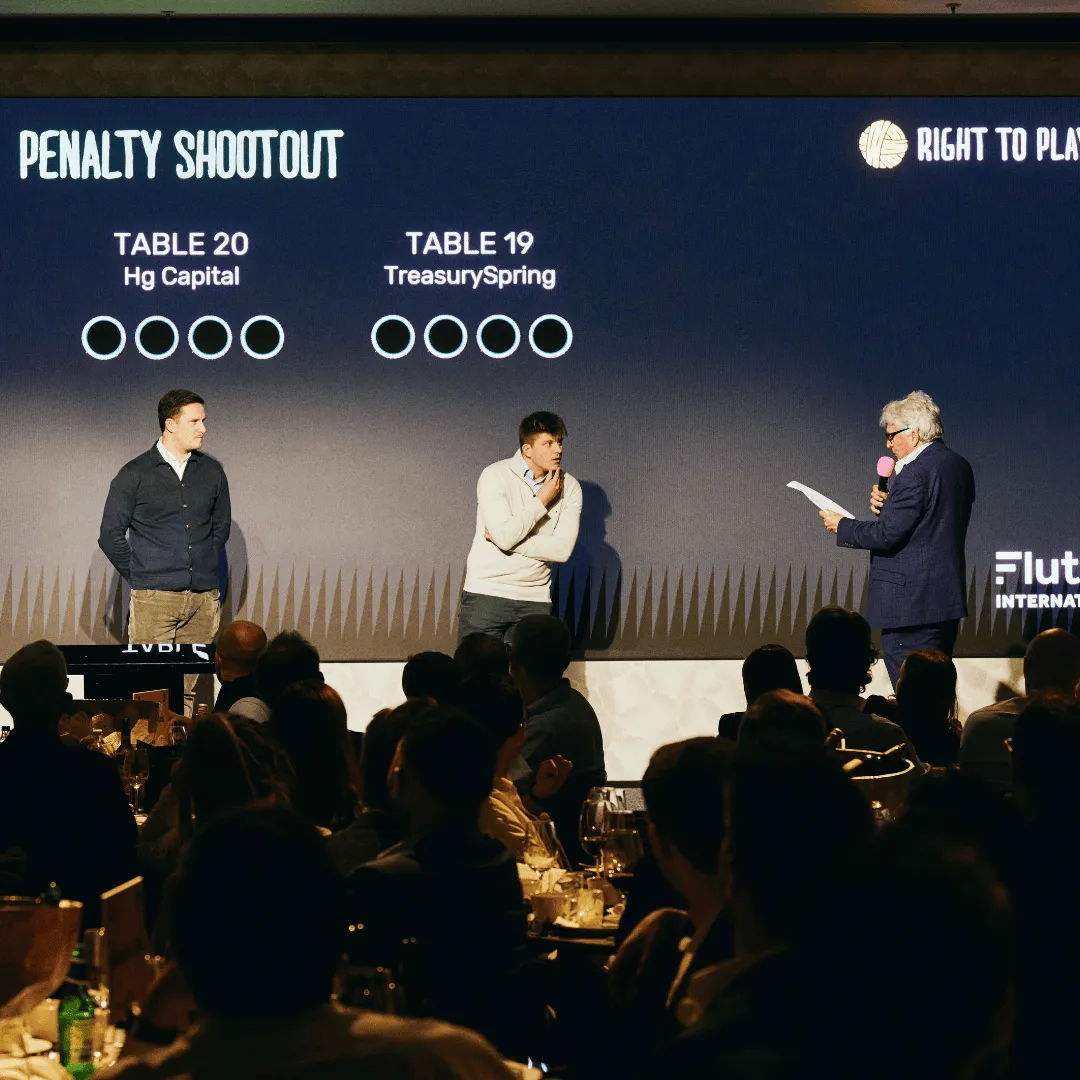 Three men stand on stage answering the penalty shoot out questions asked by John Inverdale